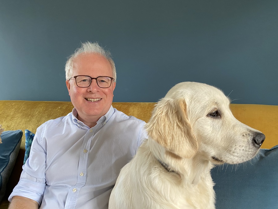 a photo of partner Adrian Budgen sat with his golden retriever