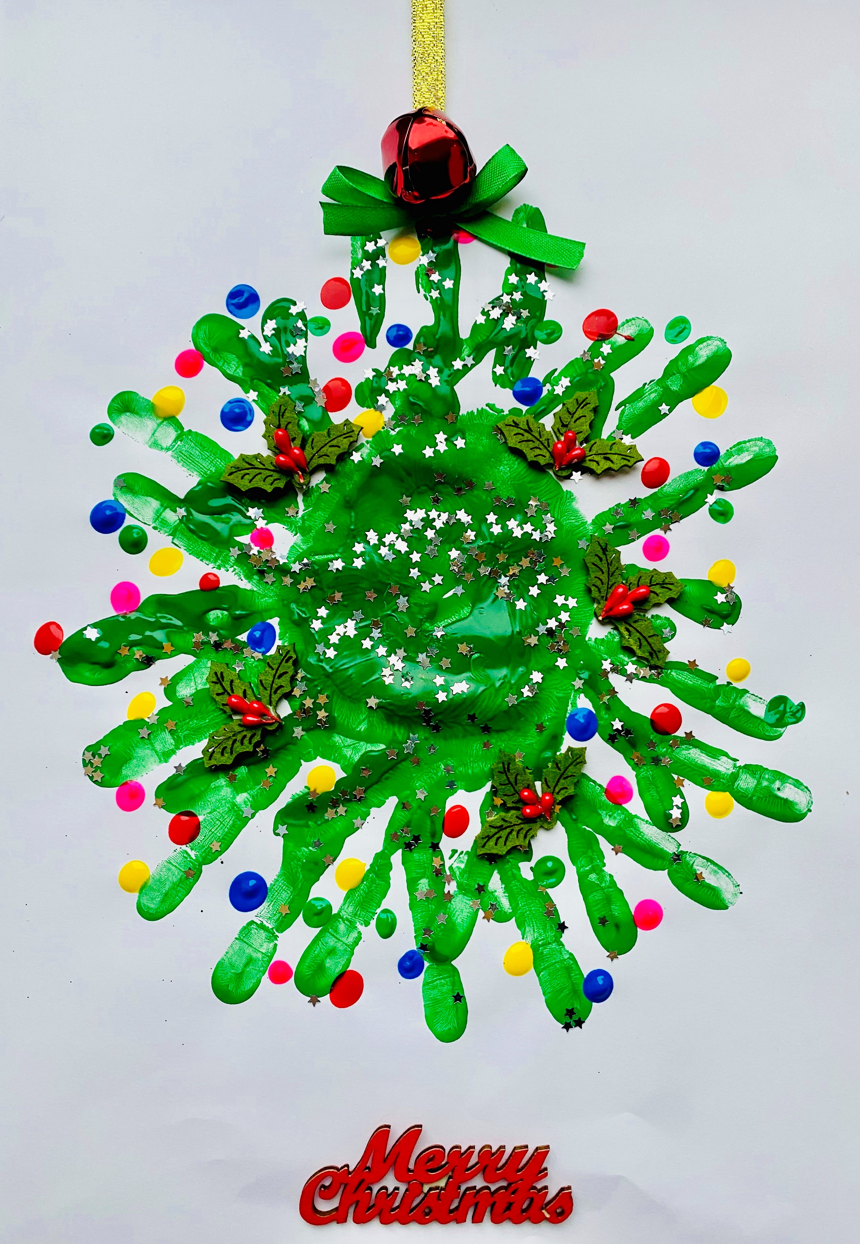 Charlie Smith's entry into our Christmas Card competition. It features a wreath made from his parents handprints, and baubles in different colours.