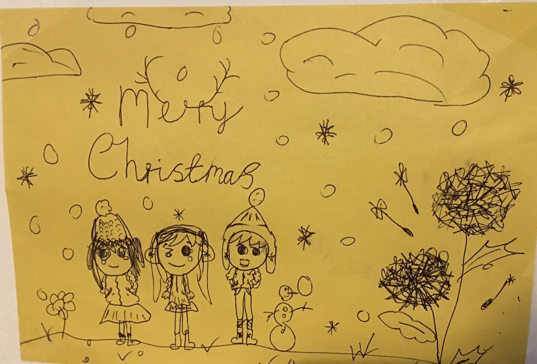 Emily Bennett's Christmas card entry. It features three cartoon children stood in the snow.