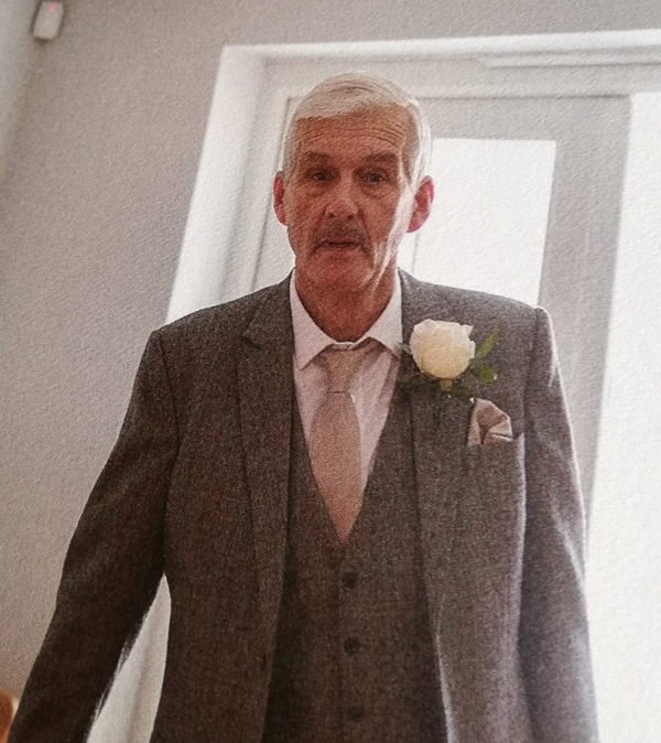 a photo of Mick in his suit at a wedding